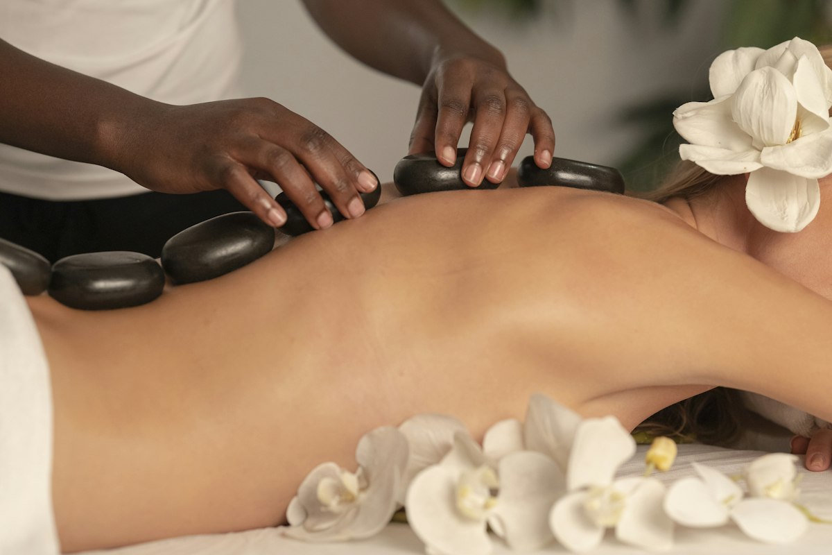 Hot stone body treatment with orchids