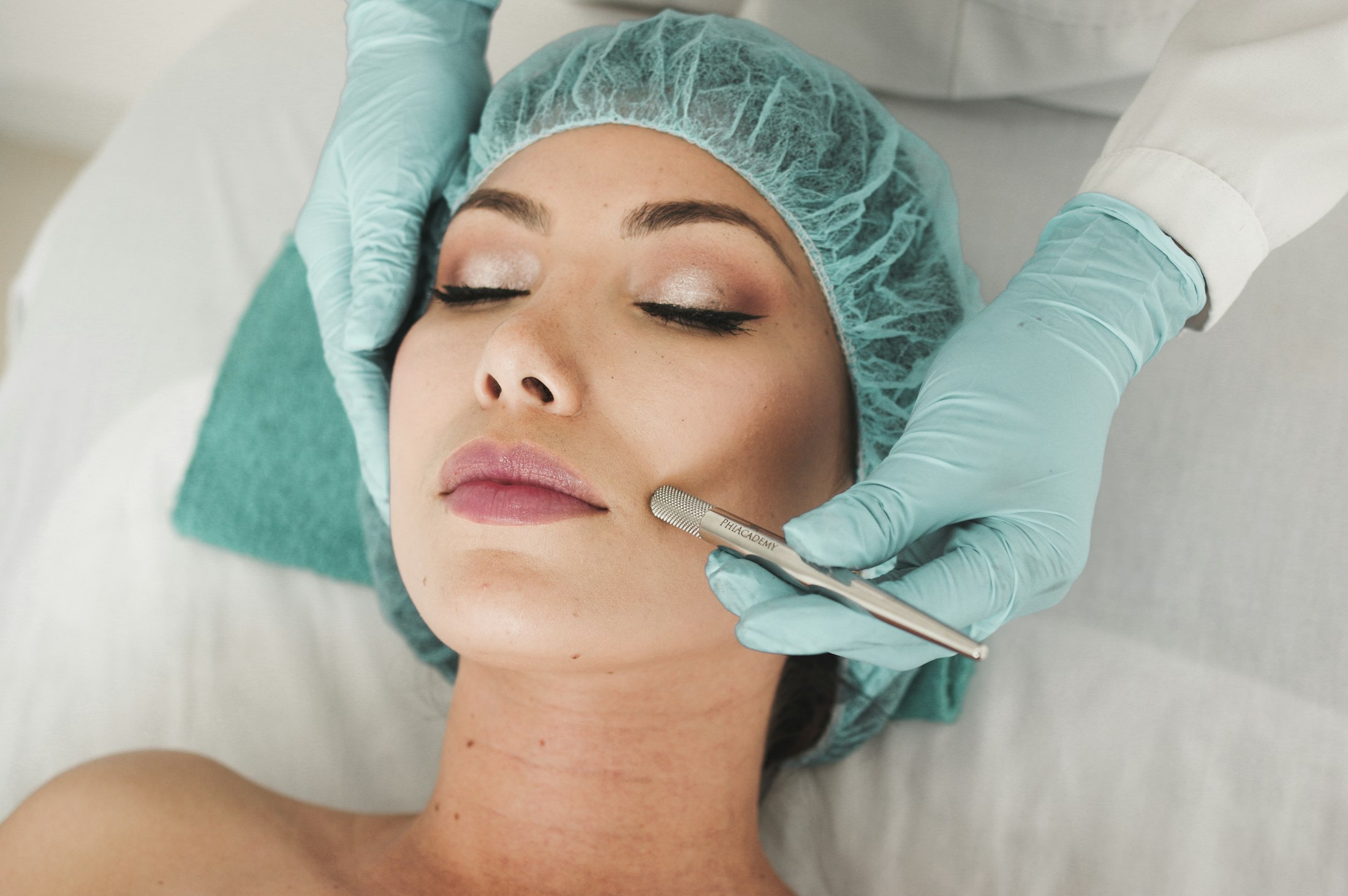 Woman with radiant skin receiving a facial treatment